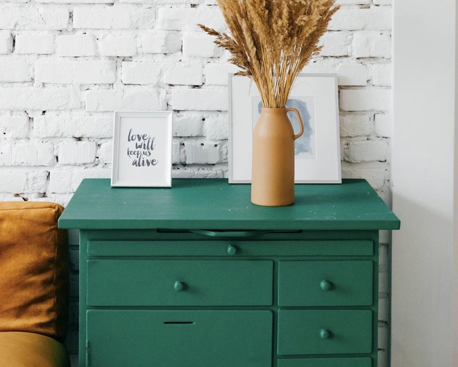 Picture of a drawer with a flower pot and a few photo frames.